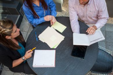 A group of coworkers meeting and forming a strategy