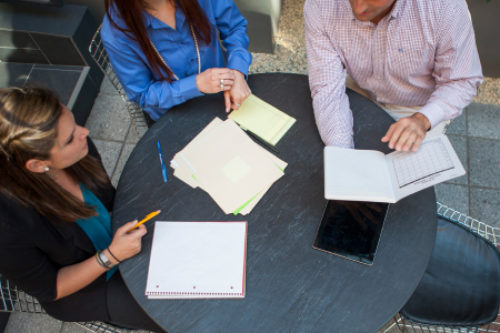 A group of coworkers meeting and forming a strategy