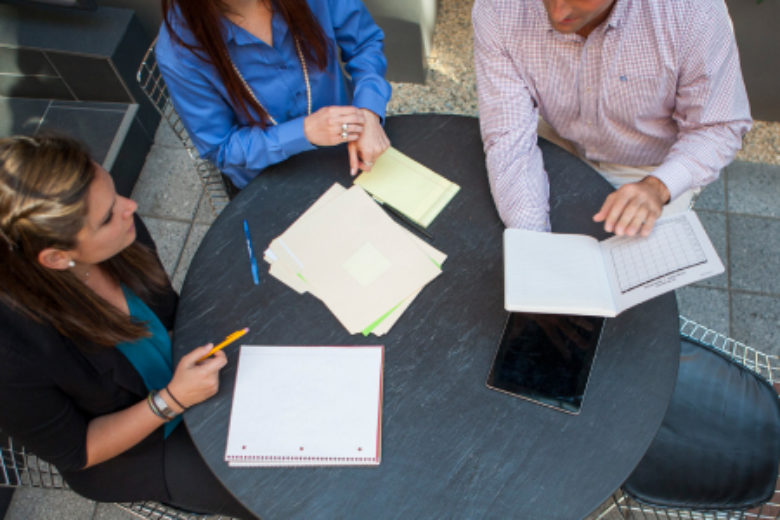 A group of coworkers meeting and forming a strategy