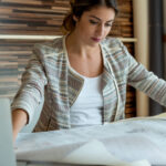 Young woman in business casual dress reviewing real estate documents